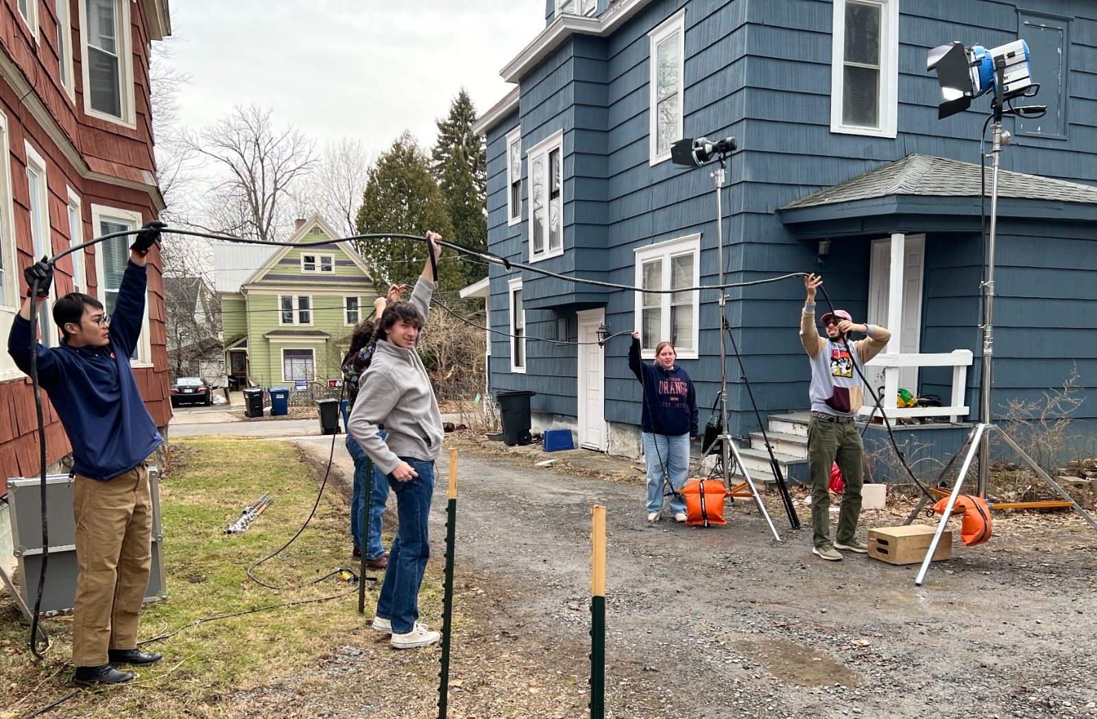 Student crew running cable on the set of Spiral